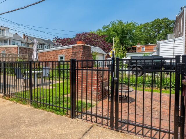 Black Aluminum Fence & Brick Patio