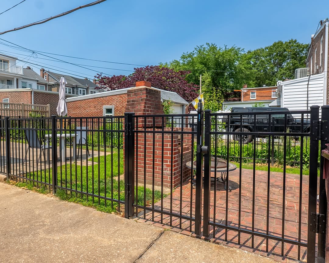 Full view of black aluminum fence and brick patio in Delaware