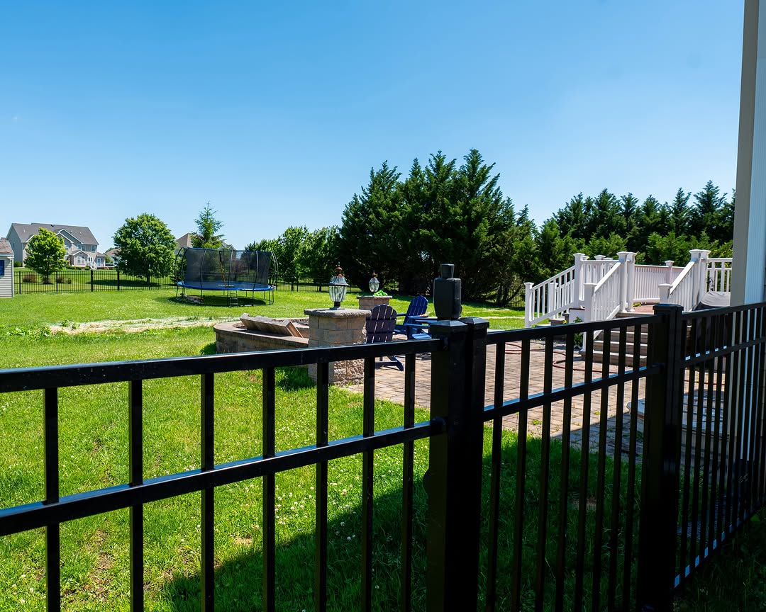 Full view of black aluminum fence and fire pit patio in Delaware