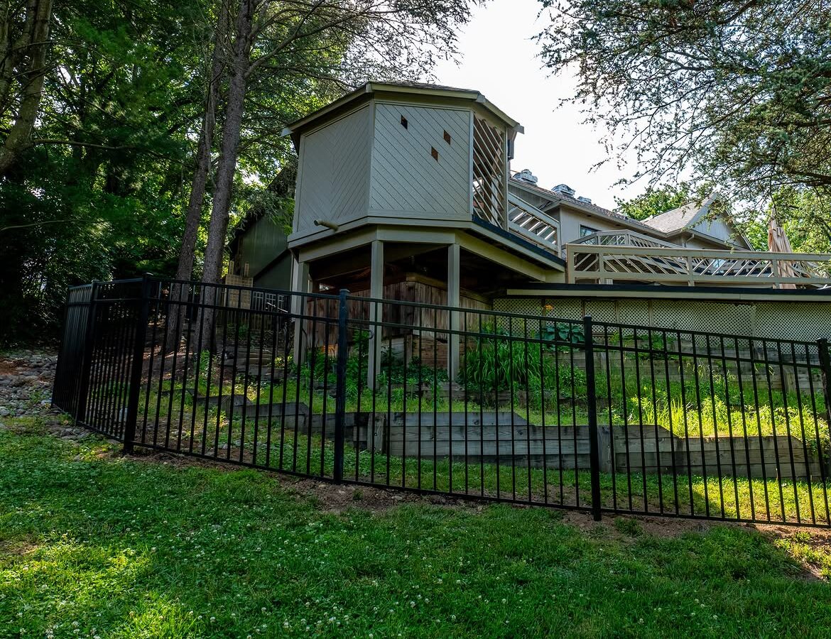 Property line view of black aluminum fence in Delaware