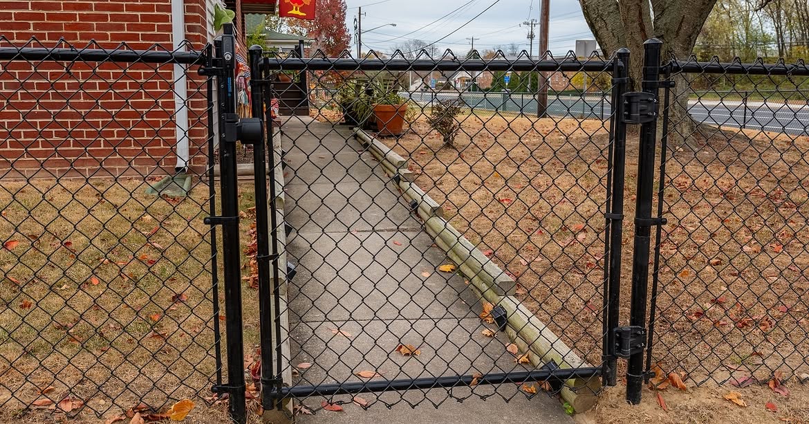 Gate detail of black chain link fence in Delaware
