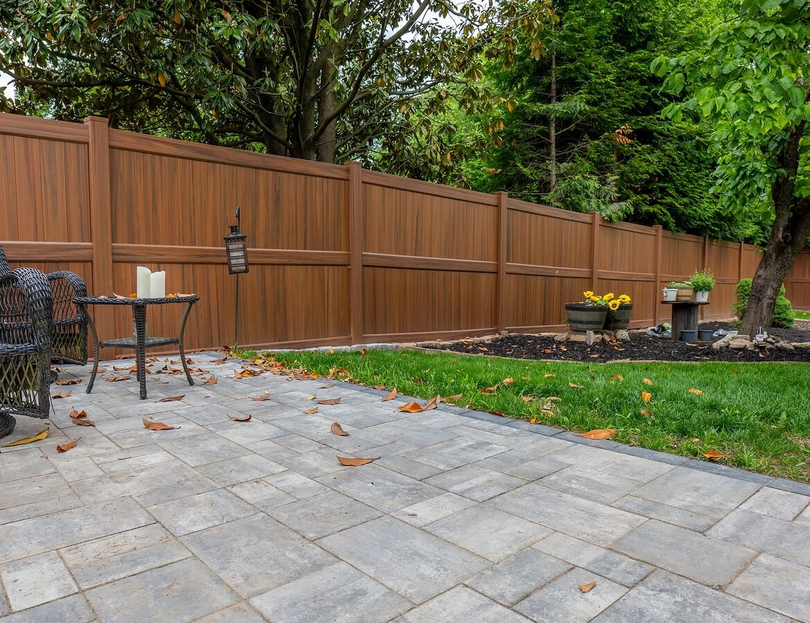 Full view of brown vinyl privacy fence and paver patio in North Wilmington, DE