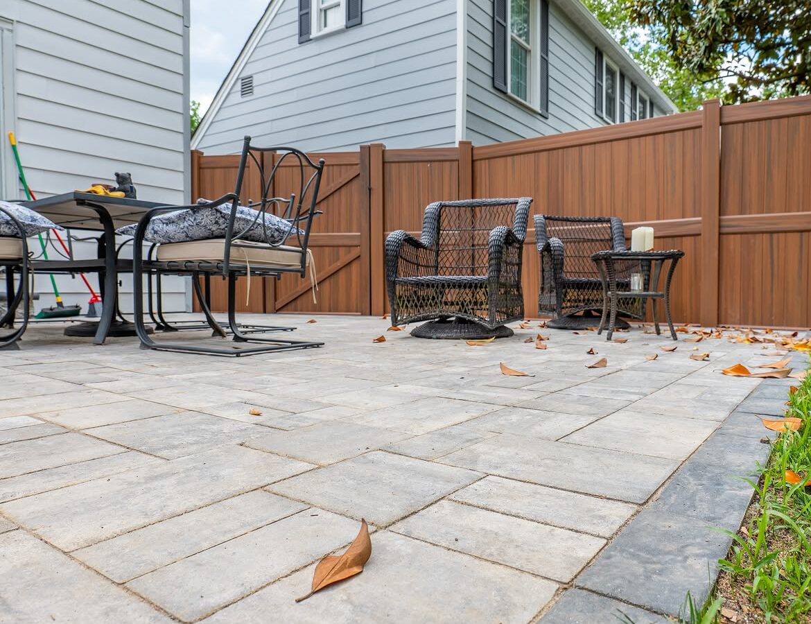 Angled view of brown vinyl privacy fence and paver patio in North Wilmington, DE