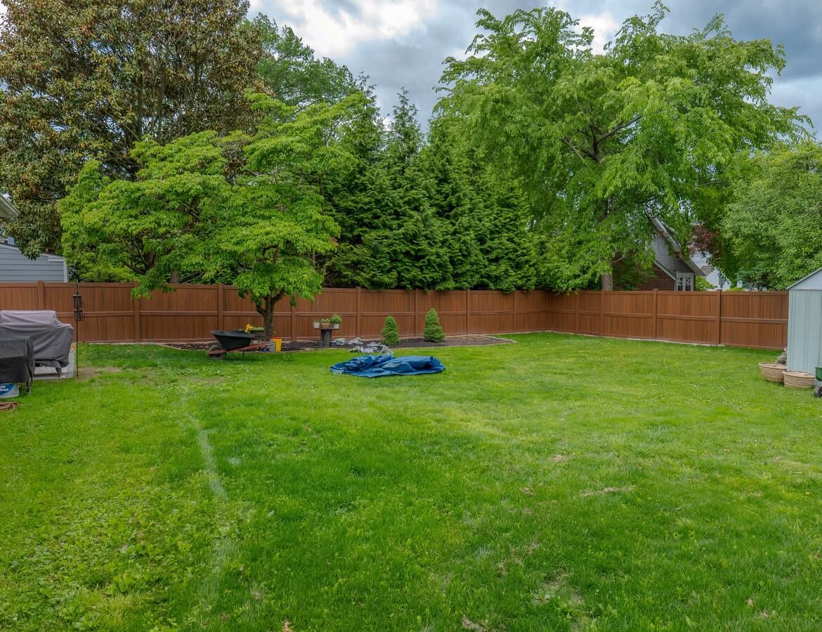 Close-up of brown vinyl privacy fence and paver patio in North Wilmington, DE