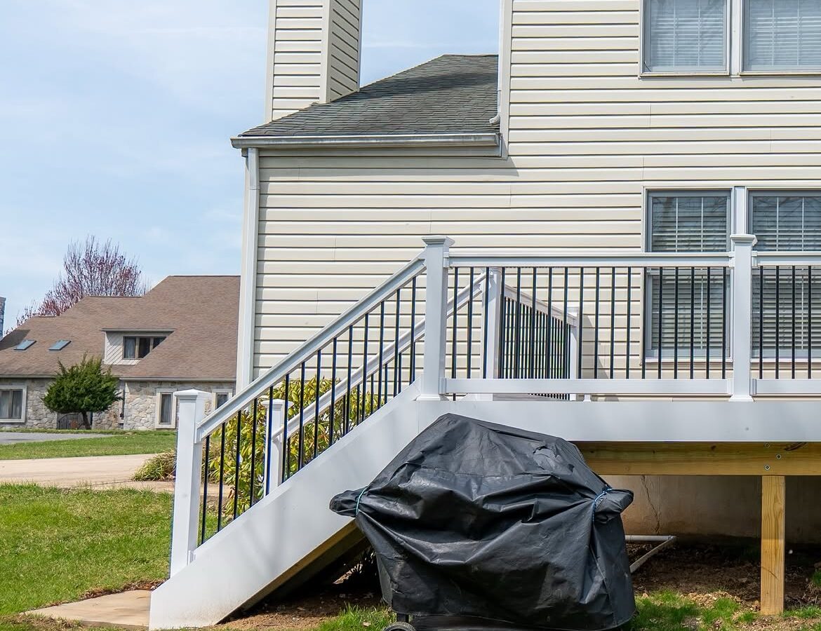 Property line view of composite deck with white rails in Delaware