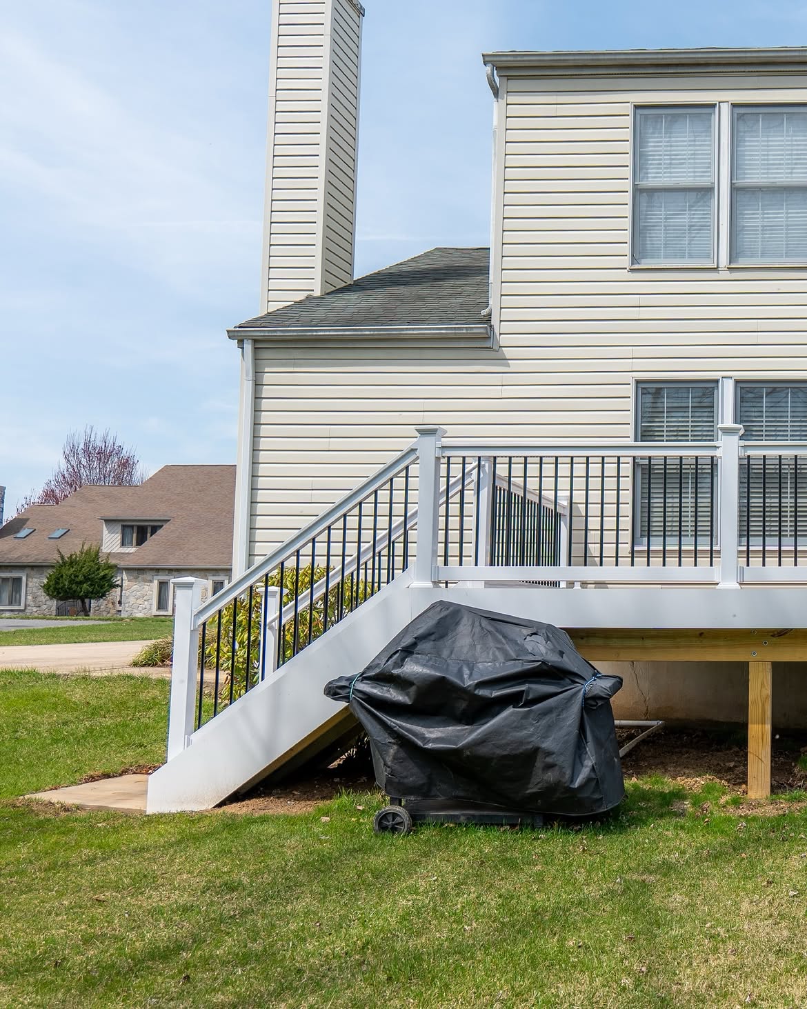 Property line view of composite deck with white rails in Delaware