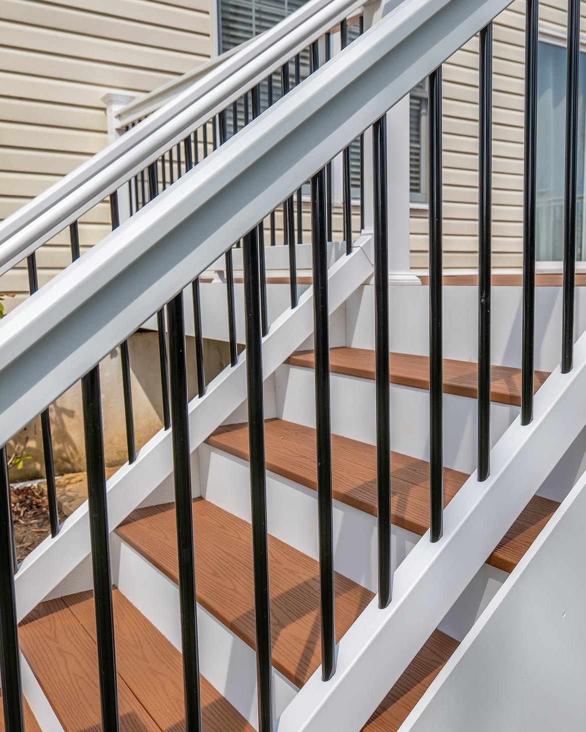 Rear yard view of composite deck with white rails in Delaware