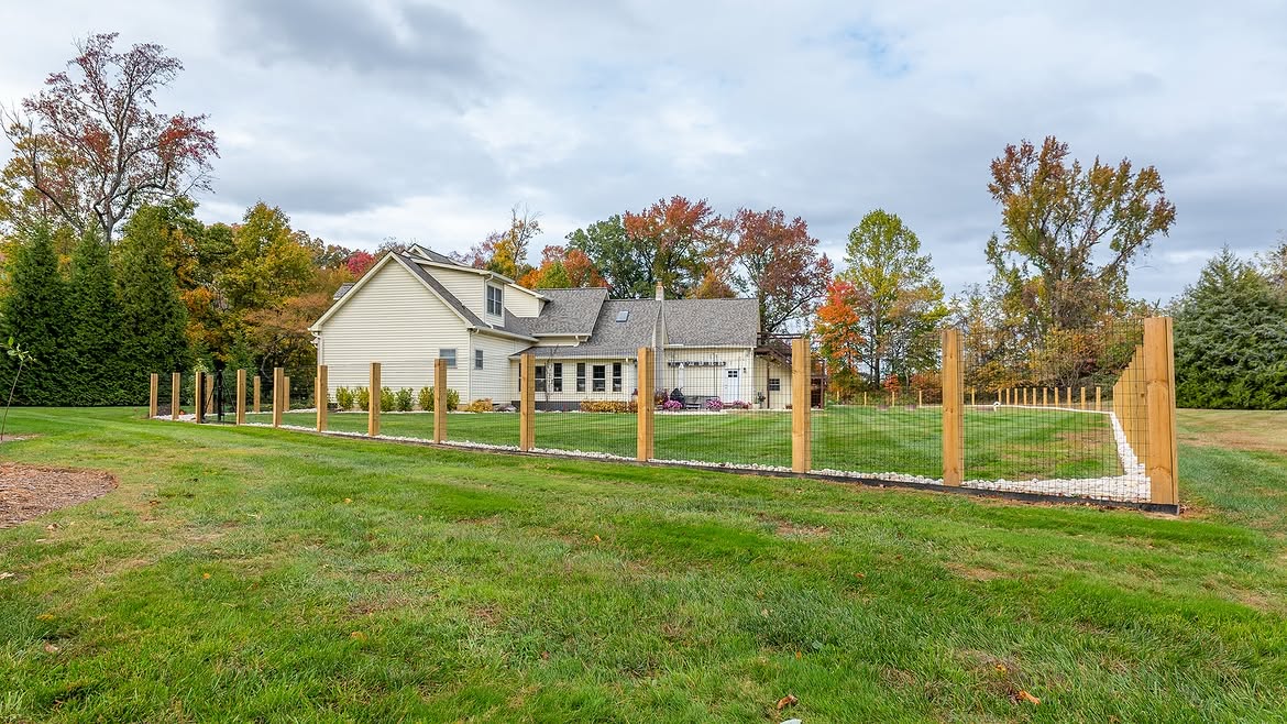Angled view of custom wire fence on cedar posts in Townsend, DE