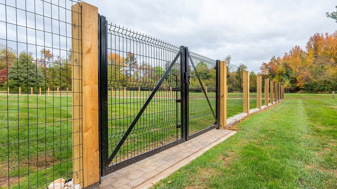 Open gate view of custom wire fence on cedar posts in Townsend, DE