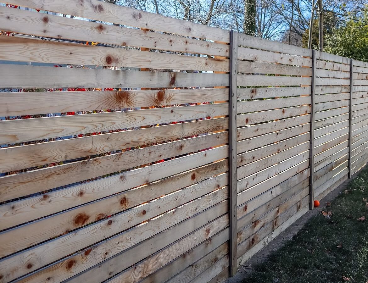 Property line view of custom wood fence in Delaware