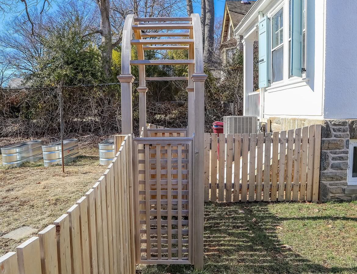 Open gate view of custom wood fence in Delaware