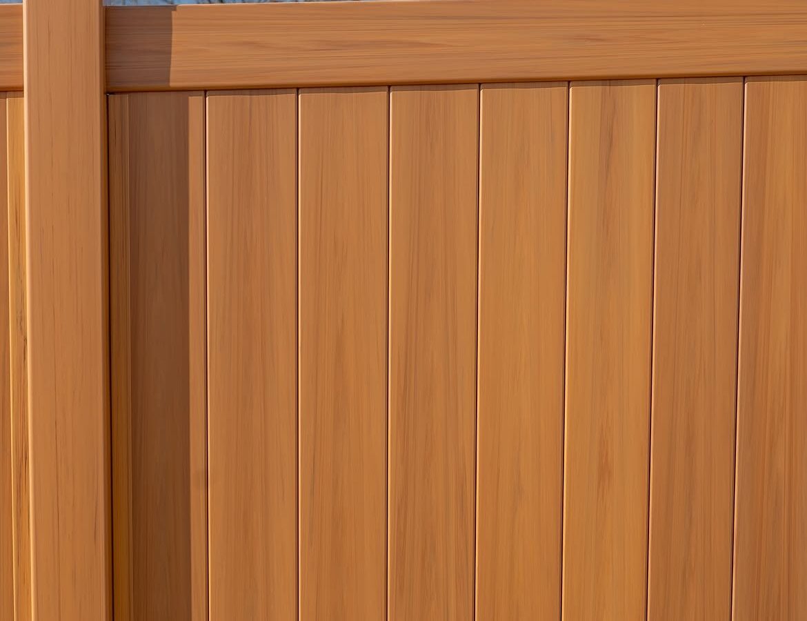Full view of light tan wood grain vinyl fence in Aston, PA