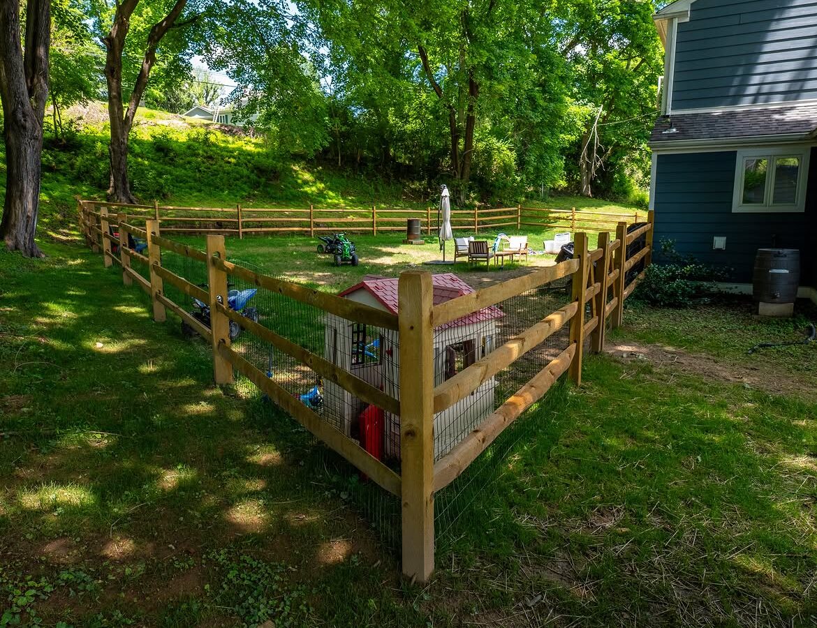 Angled view of wood post-and-rail fence with wire mesh in Delaware