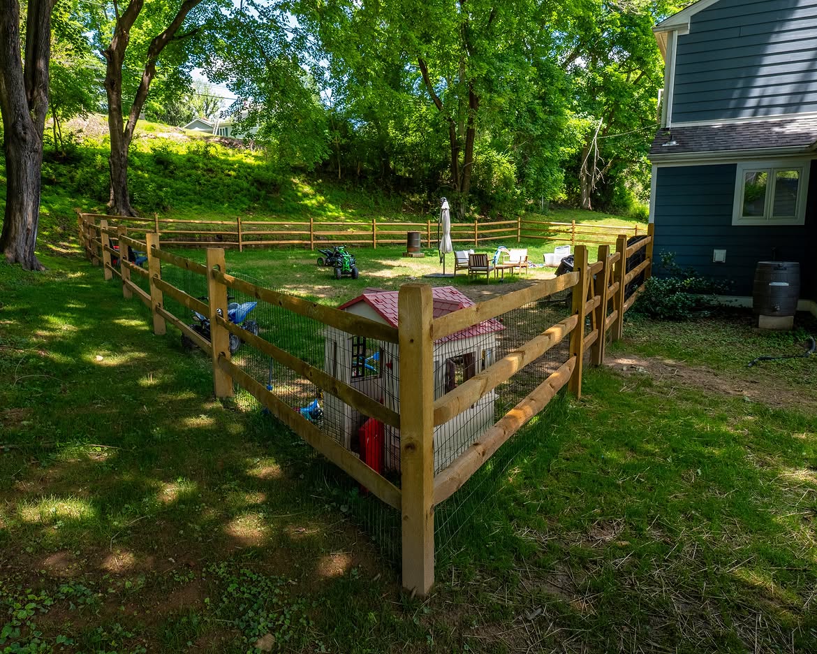 Angled view of wood post-and-rail fence with wire mesh in Delaware