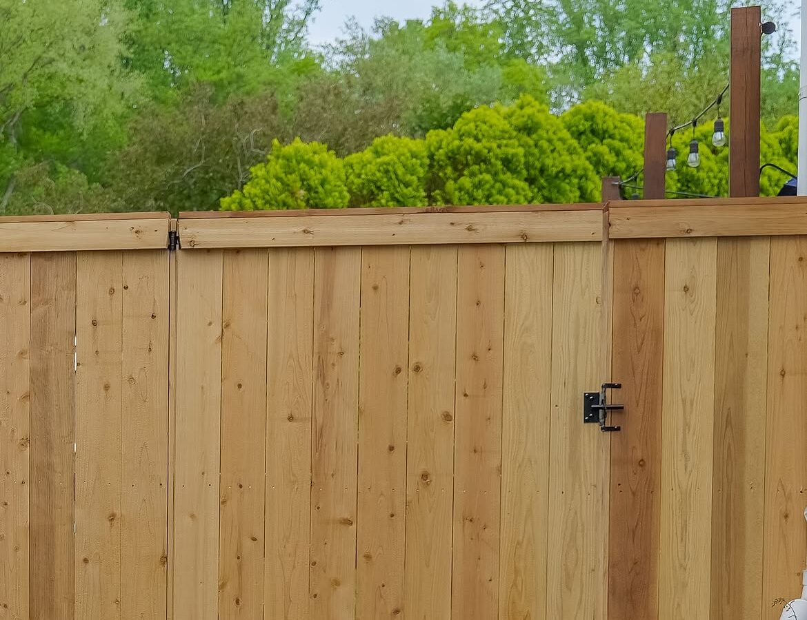 Gate detail of red cedar cap and trim fence in Delaware