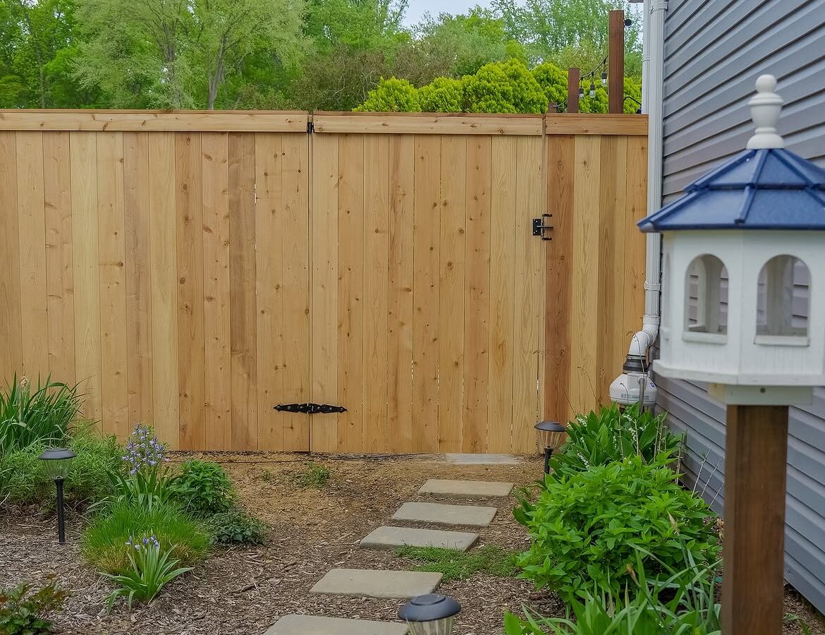 Gate detail of red cedar cap and trim fence in Delaware
