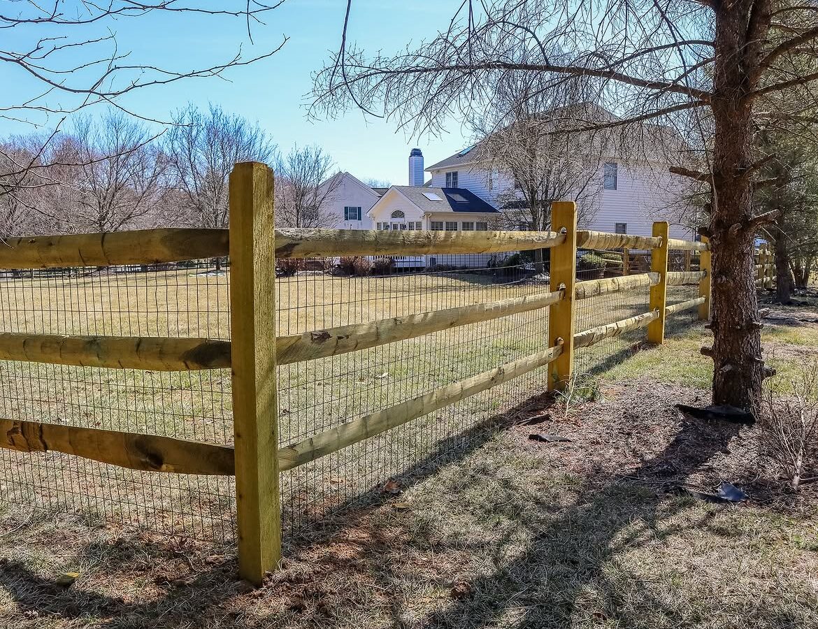 Corner detail of split rail fence with wire backing in Delaware