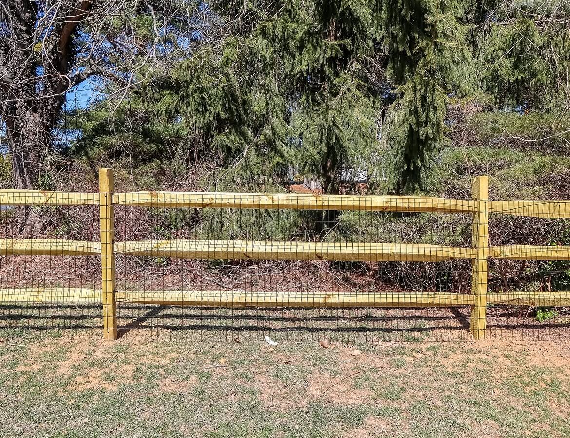 Side view of split rail fence with wire backing in Delaware
