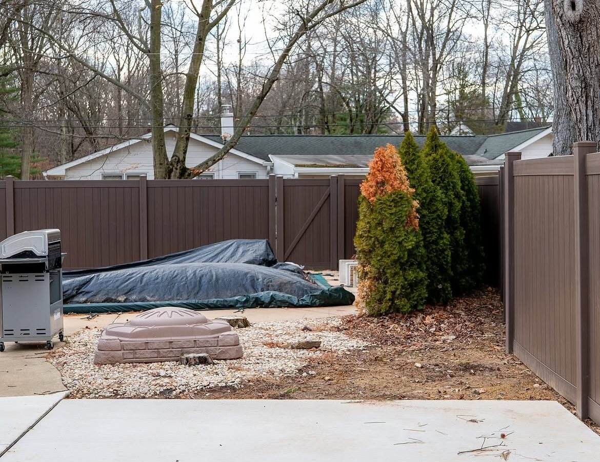 Full view of tan and brown wood grain vinyl fence in Delaware