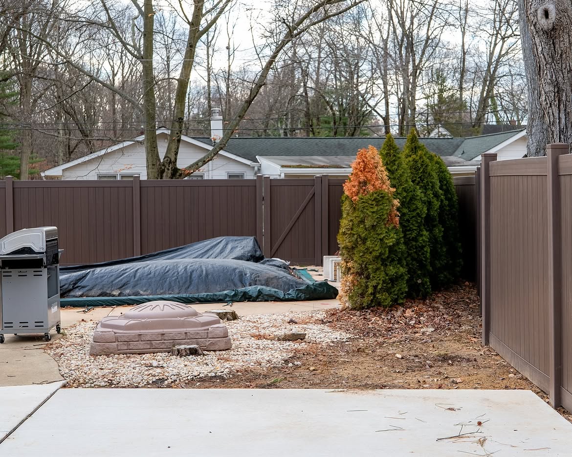 Full view of tan and brown wood grain vinyl fence in Delaware