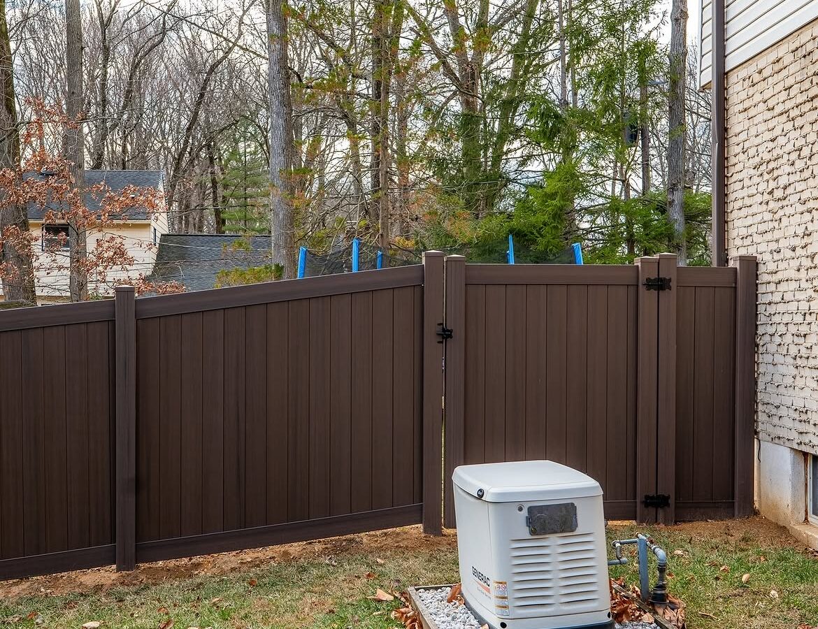 Gate and fence view of tan and brown wood grain vinyl fence in Delaware