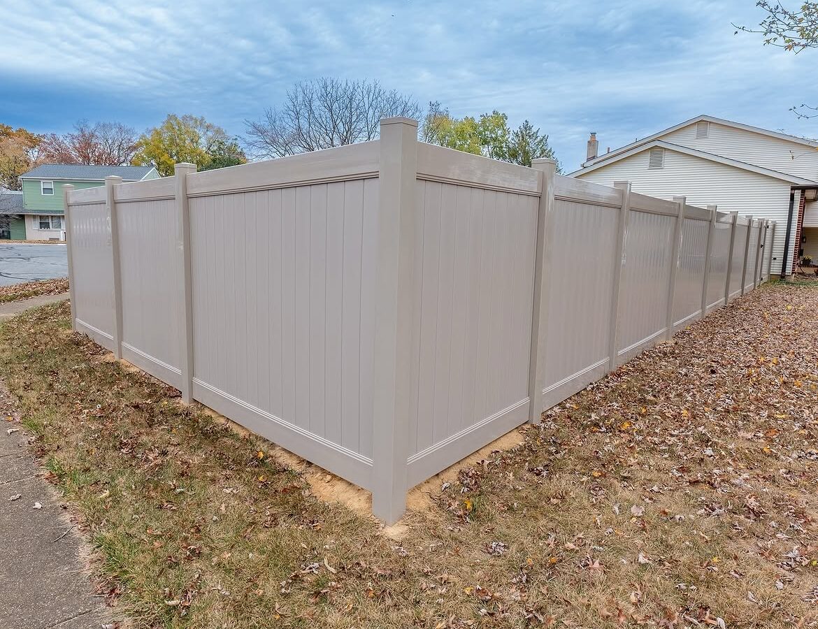 Angled view of tan vinyl privacy fence in Delaware