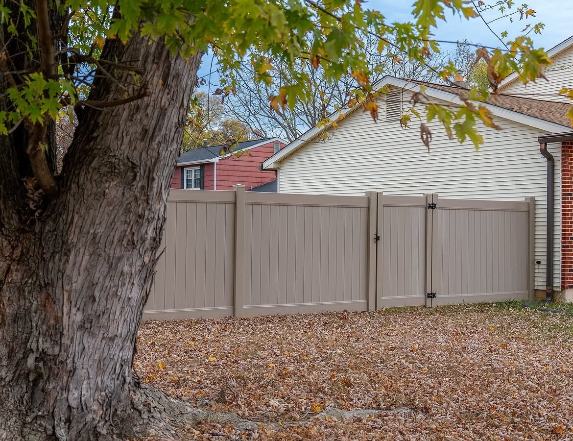 Gate detail of tan vinyl privacy fence in Delaware