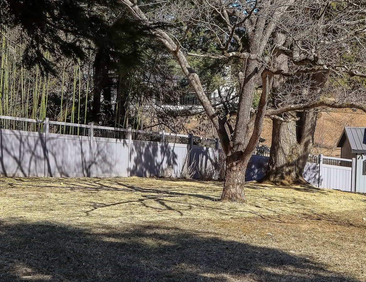 Wide view of vinyl ranch rail and privacy fence in Delaware