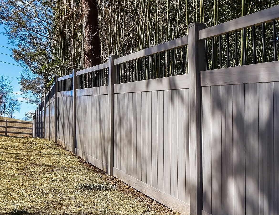 Rear yard view of vinyl ranch rail and privacy fence in Delaware