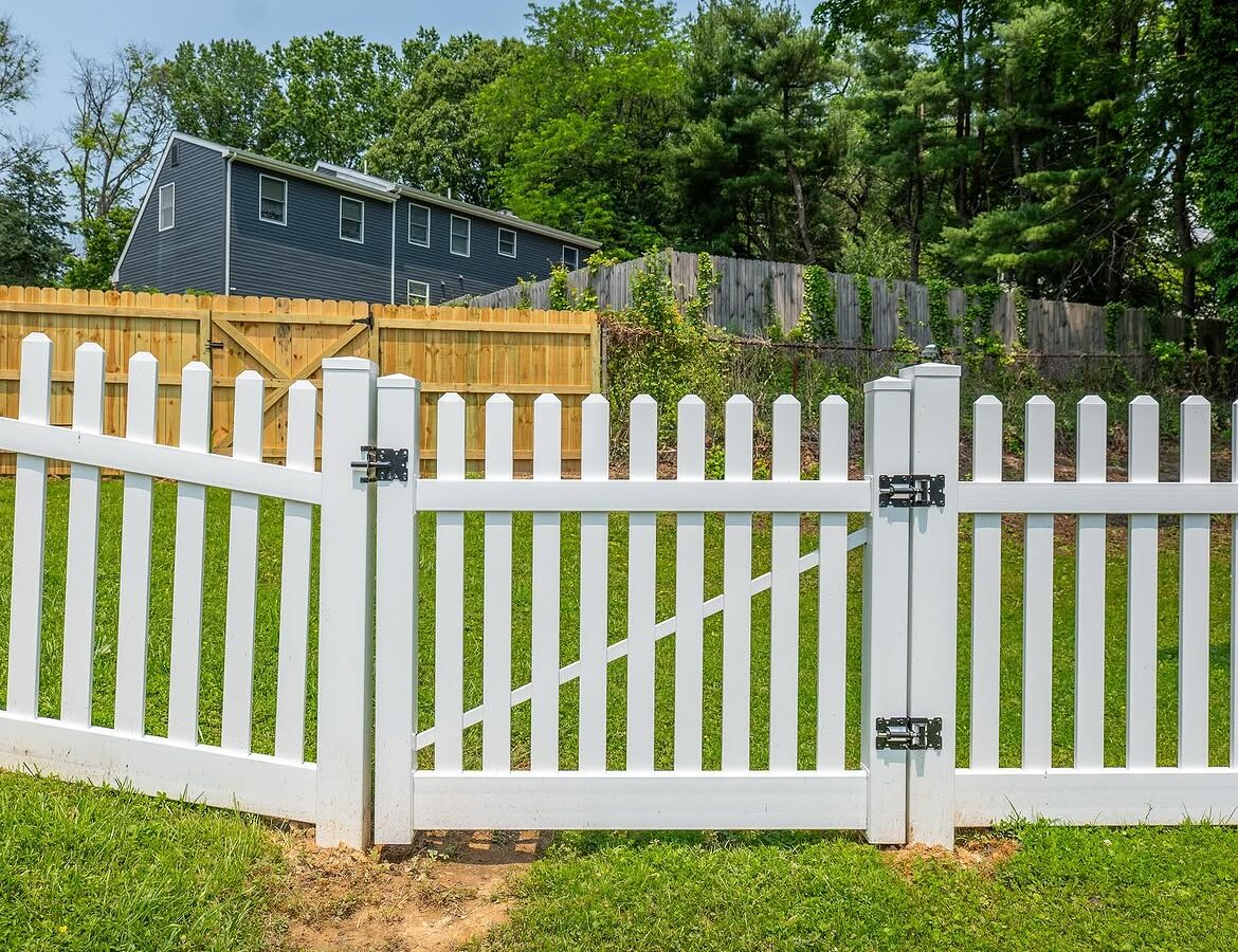 Gate detail of white vinyl picket fence in Delaware