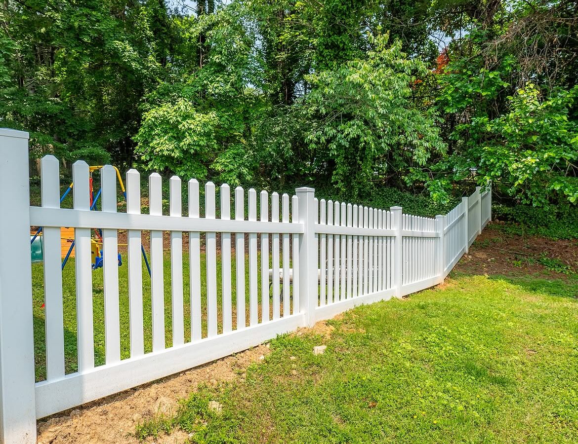 Angled view of white vinyl picket fence in Delaware
