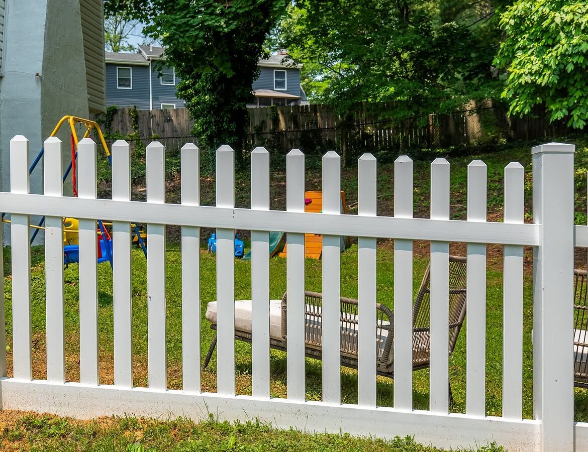 Corner detail of white vinyl picket fence in Delaware