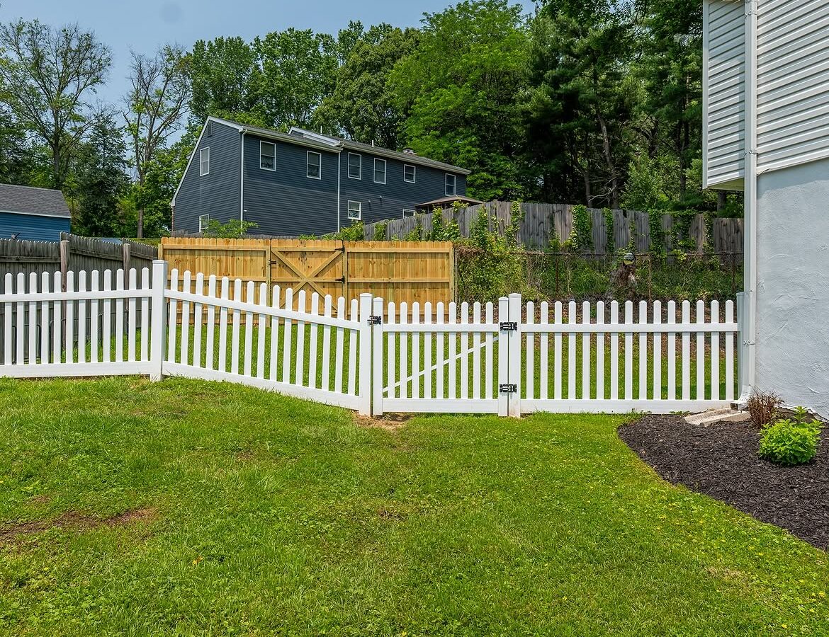 Gate and fence view of white vinyl picket fence in Delaware