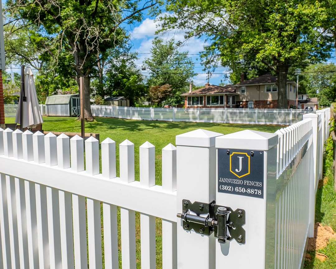Gate detail of white vinyl picket fence in Delaware