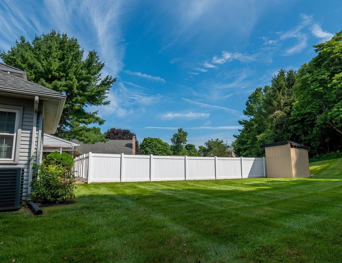 Angled view of white vinyl pool fence in Delaware