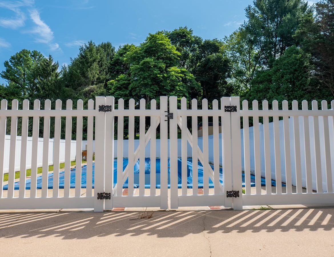 Gate detail of white vinyl pool fence in Delaware