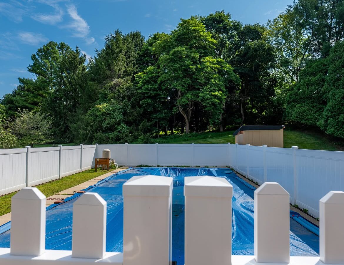 Side view of white vinyl pool fence in Delaware
