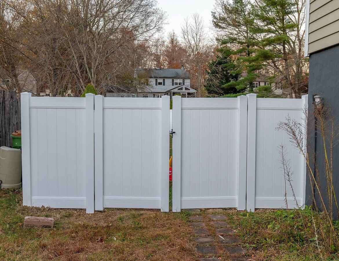 Gate and fence view of white vinyl privacy fence in Delaware