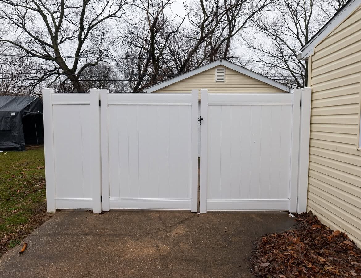 Gate detail of white vinyl privacy fence in Delaware