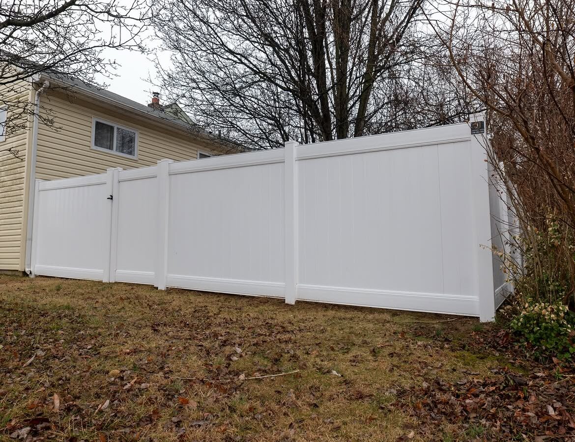 Angled view of white vinyl privacy fence in Delaware