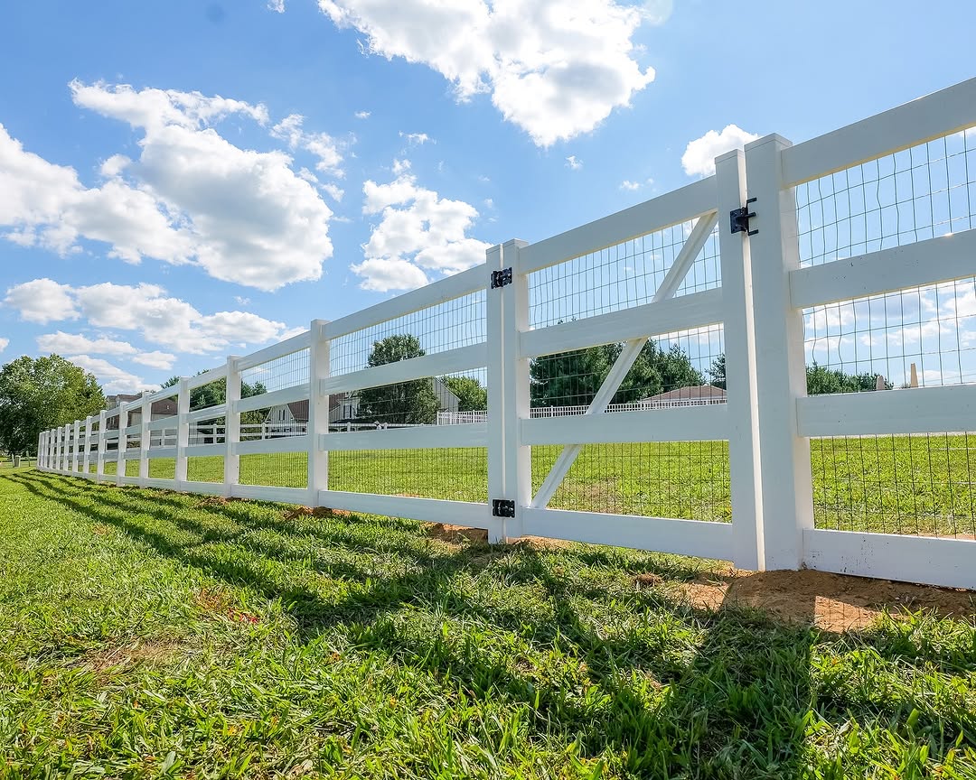 Gate detail of white vinyl ranch rail fence in Delaware
