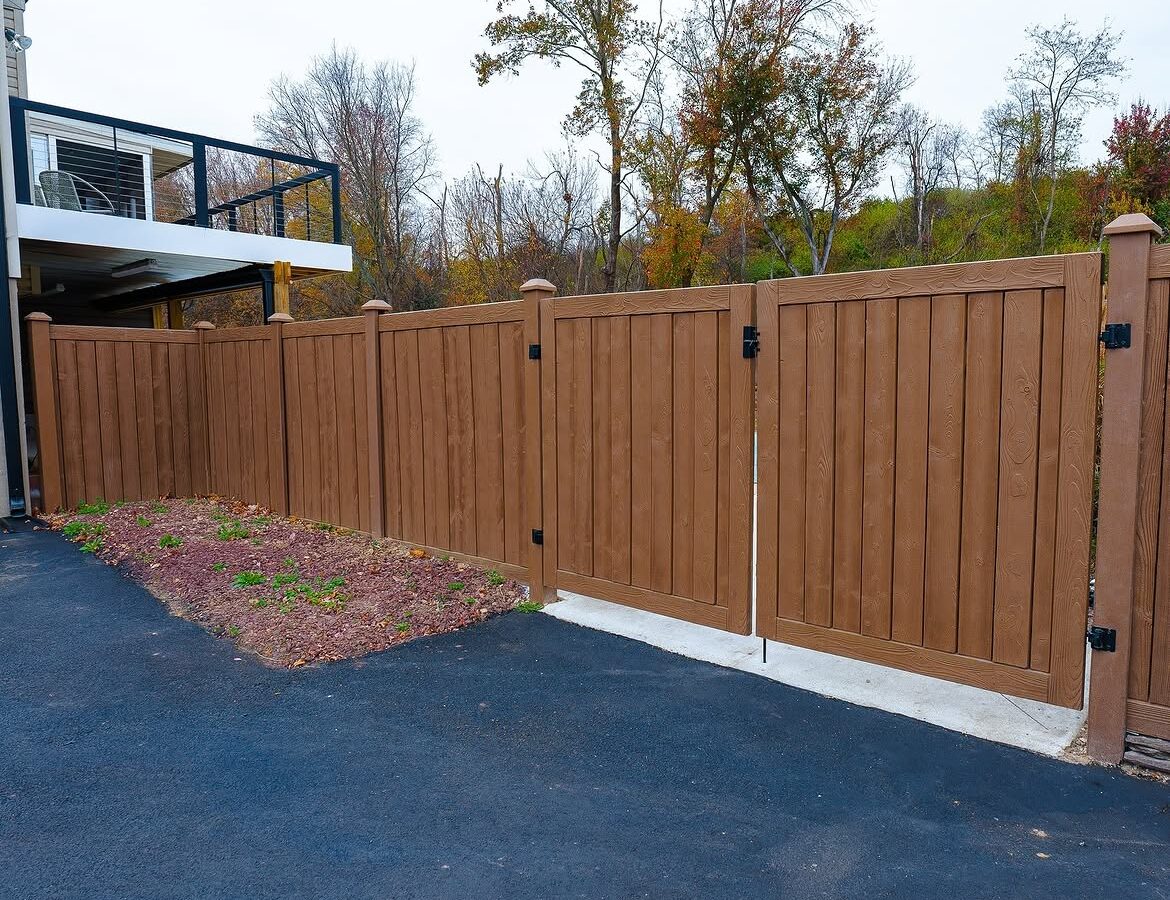 Open gate view of wood grain vinyl driveway gate in Delaware