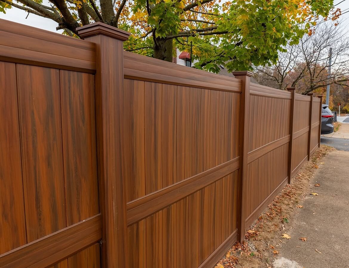 Side view of wood grain vinyl privacy fence in Christiana, DE