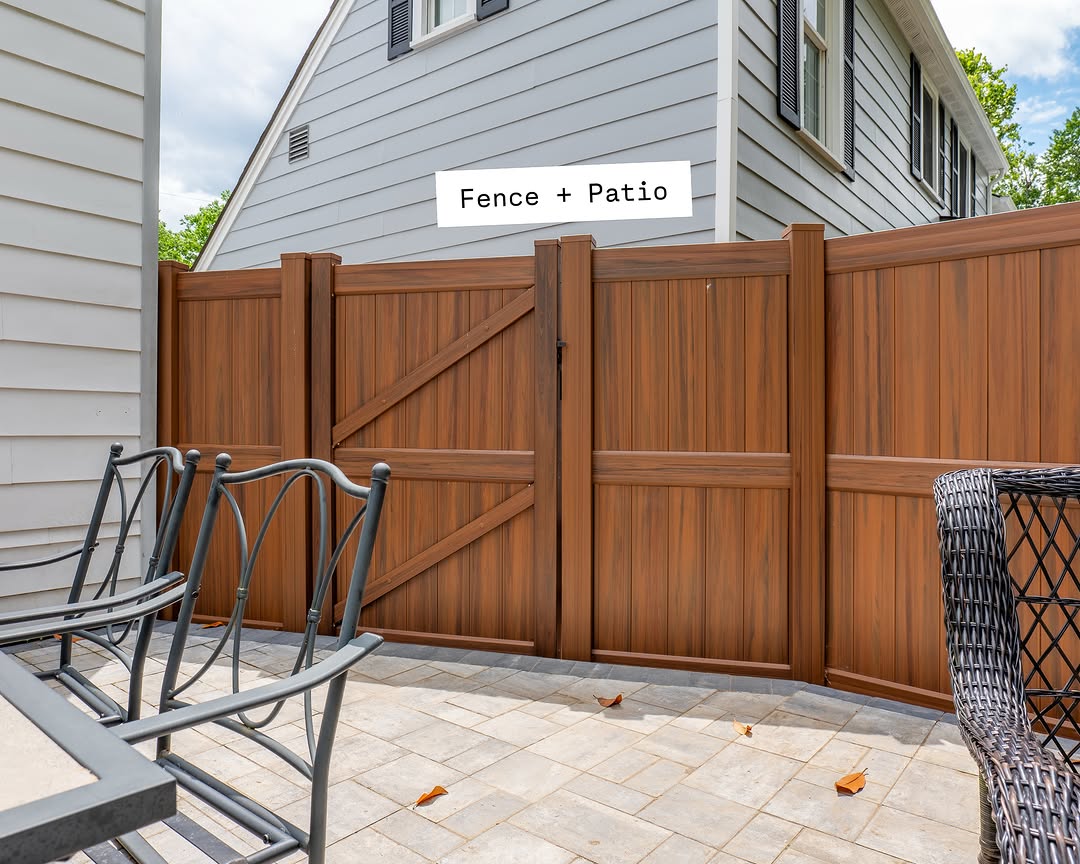 Gate detail of wood grain vinyl fence and patio in Delaware
