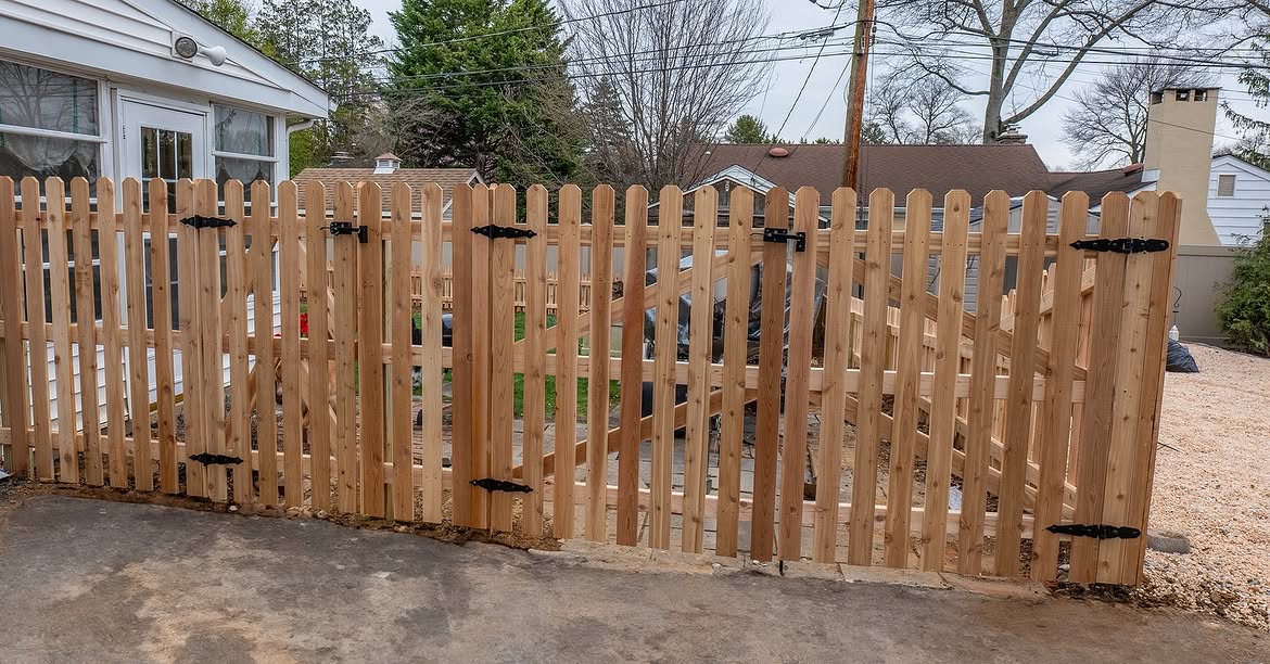 Open gate view of cedar picket fence in Wilmington, DE