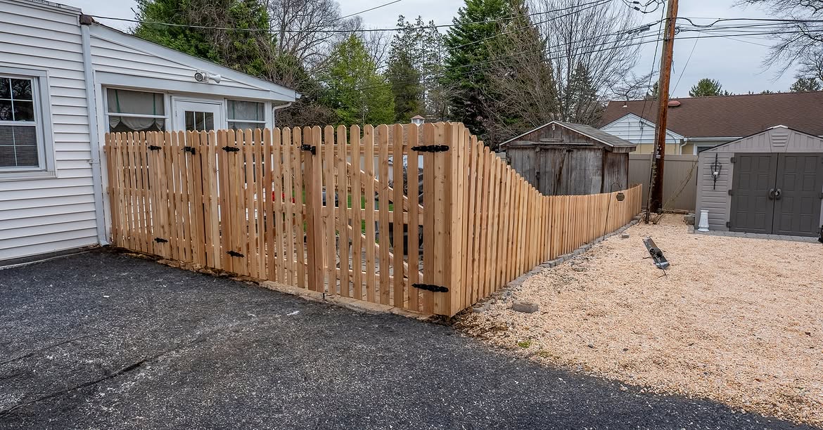 Property line view of cedar picket fence in Wilmington, DE