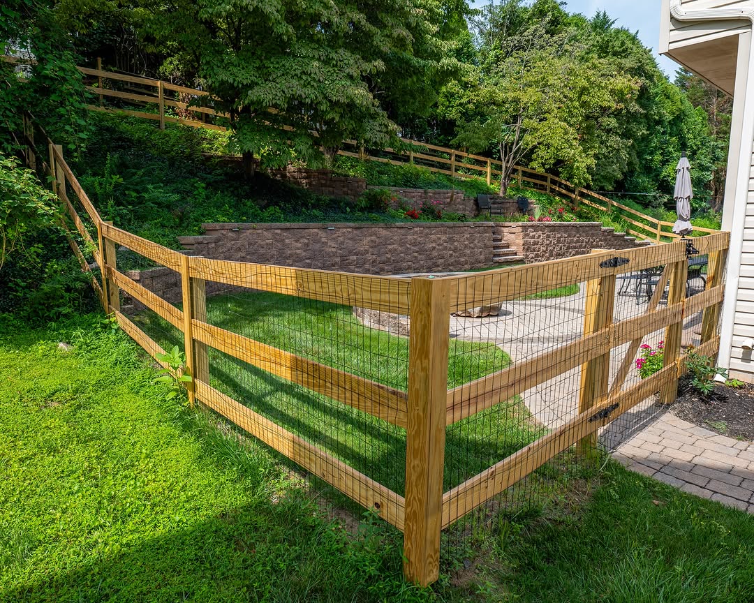 Full view of wood post-and-rail fence and paver patio in Delaware