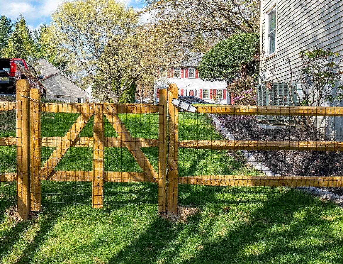 Gate detail of wood post-and-rail fence in Delaware