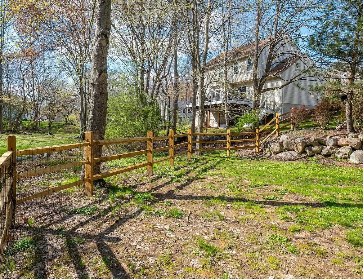 Property line view of wood post-and-rail fence in Delaware