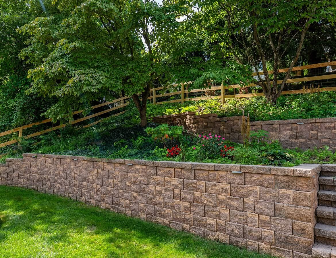 Side view of wood post-and-rail fence, paver patio and retaining wall in Delaware